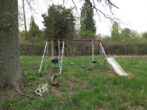 old swing set in backyard